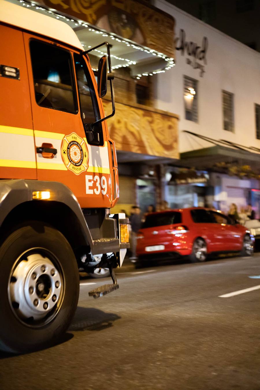 Fire truck E39 parked on a street with a red car behind