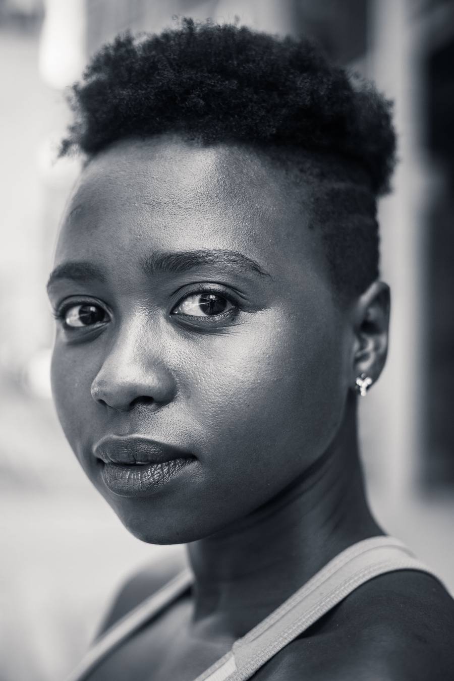 Black and white portrait of a woman with short hair and earrings